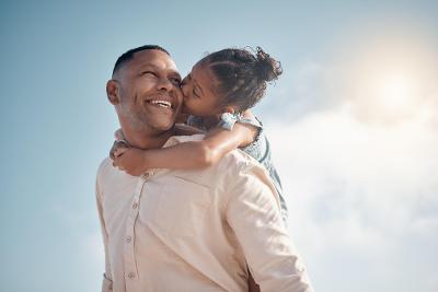 Man with young girl on shoulder kissing cheek - training Man with young girl on shoulder kissing cheek - training