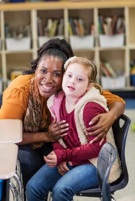 Woman with young girl on a chair team support Woman with young girl on a chair team support