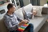 Man on sofa with musical instrument and young boy
