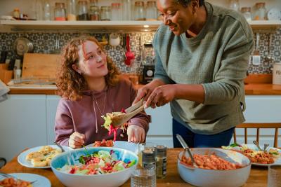 Lady serving food to teen
