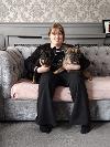 Daughter of foster carers sitting on sofa with Frenchies